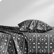 A sideview of a modern bed with a printed microfiber sheet set.