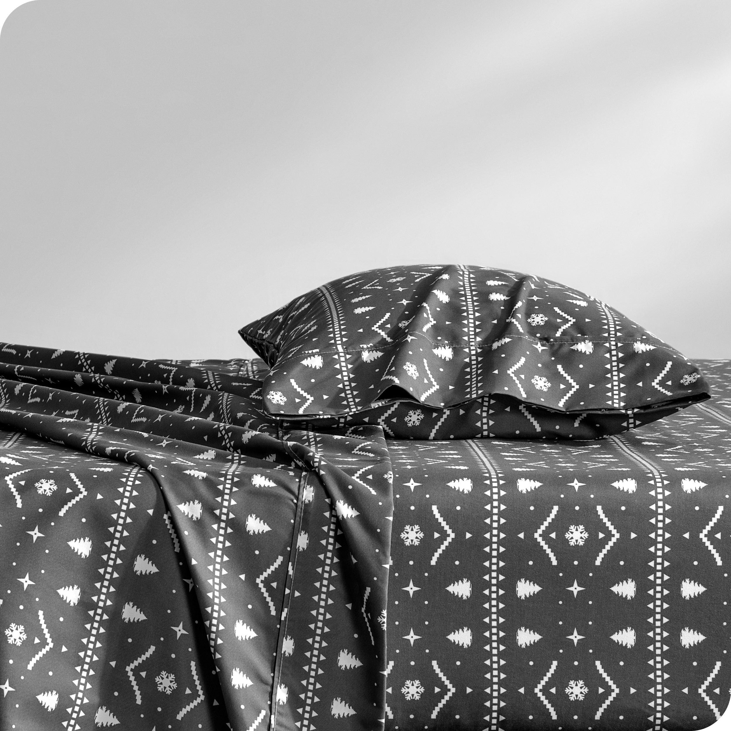 A sideview of a modern bed with a printed microfiber sheet set.