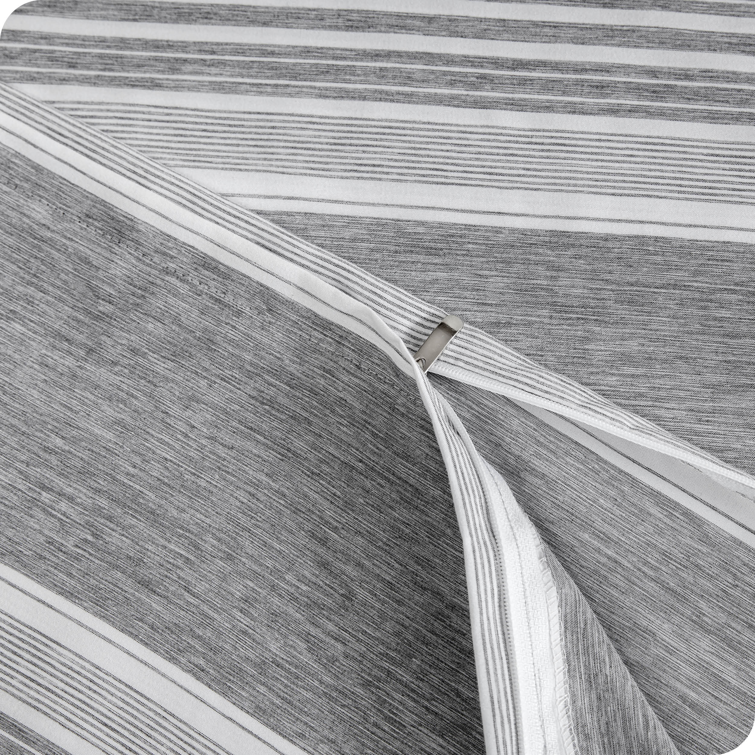 A close up view of the zipper of the microfiber duvet cover.