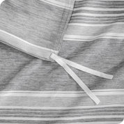 A close up view of the tie of the microfiber duvet cover.