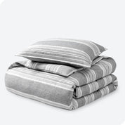 A microfiber duvet cover folded with a pillow on top.