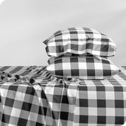 A sideview of a modern bed with a printed microfiber sheet set.