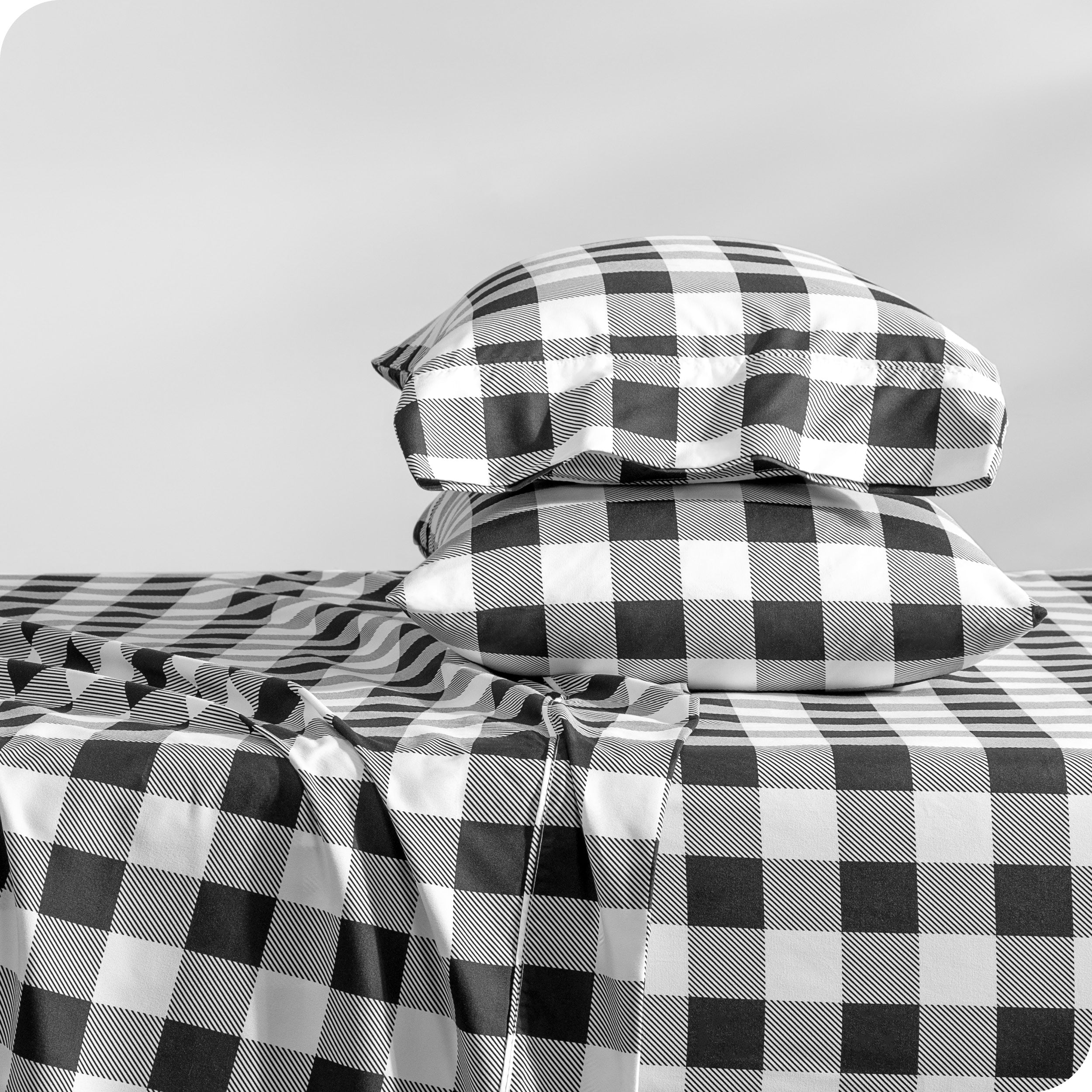 A sideview of a modern bed with a printed microfiber sheet set.