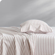 A bed with a pillow on top in our patterned microfiber sheet set.
