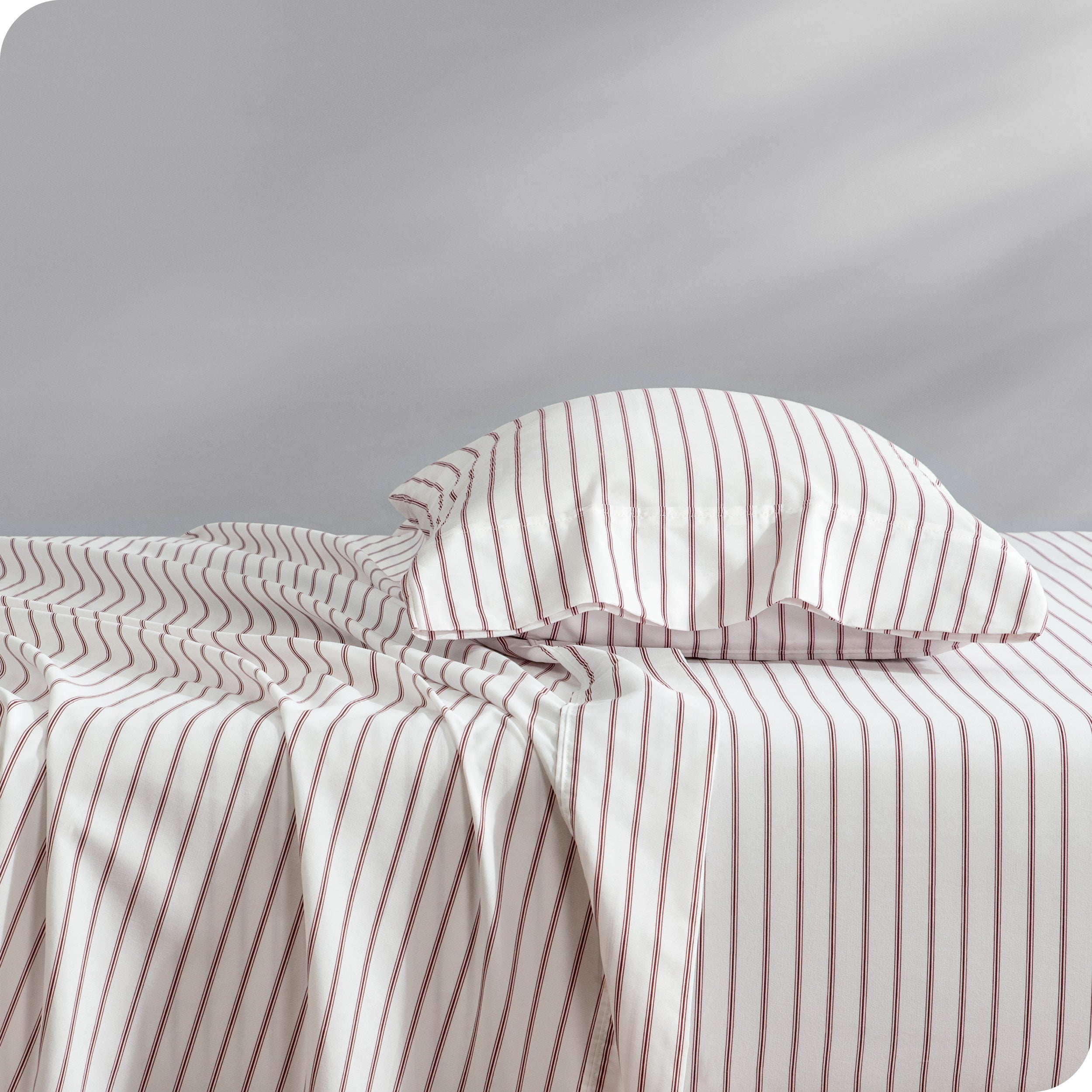 A bed with a pillow on top in our patterned microfiber sheet set.