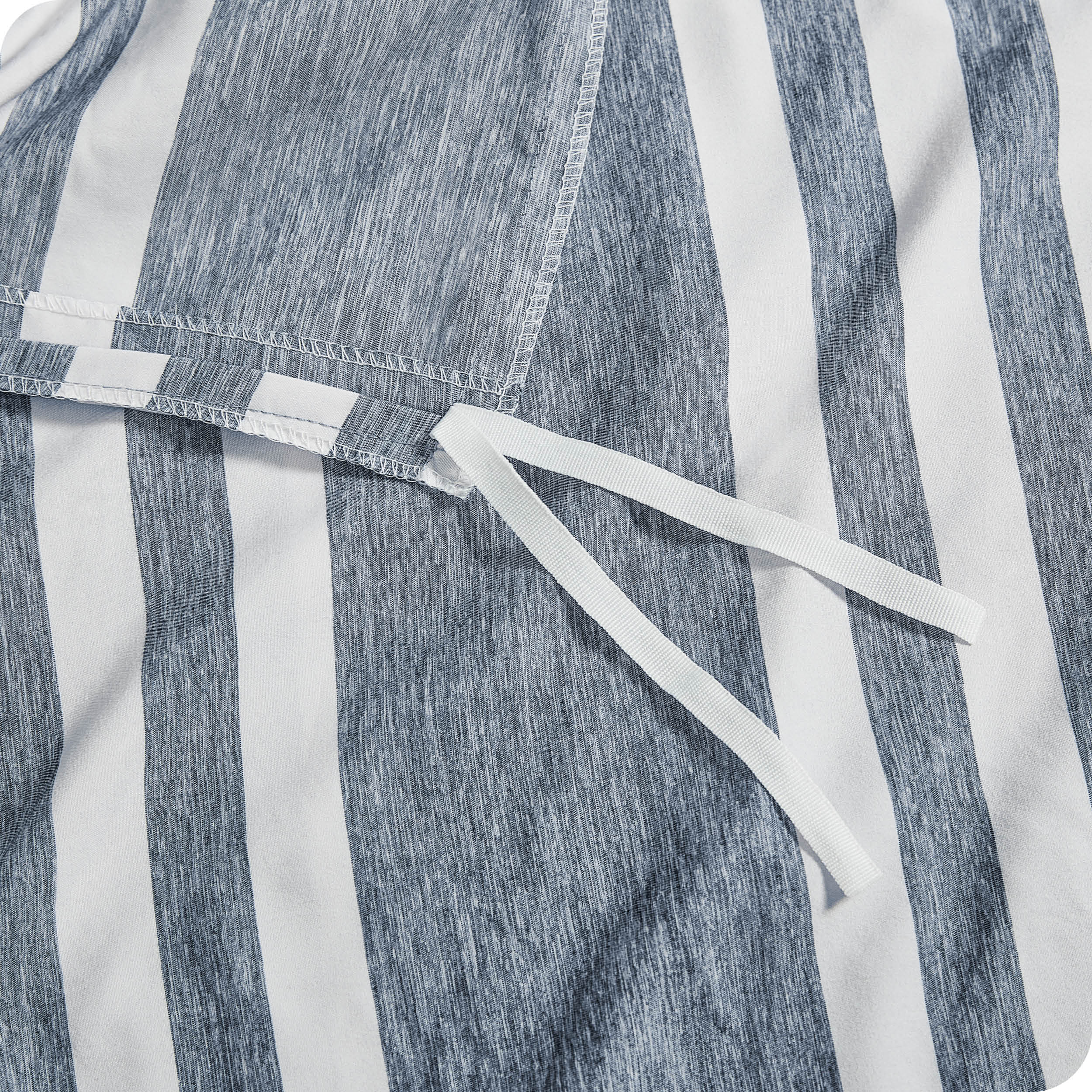 A close up view of the tie of the microfiber duvet cover.