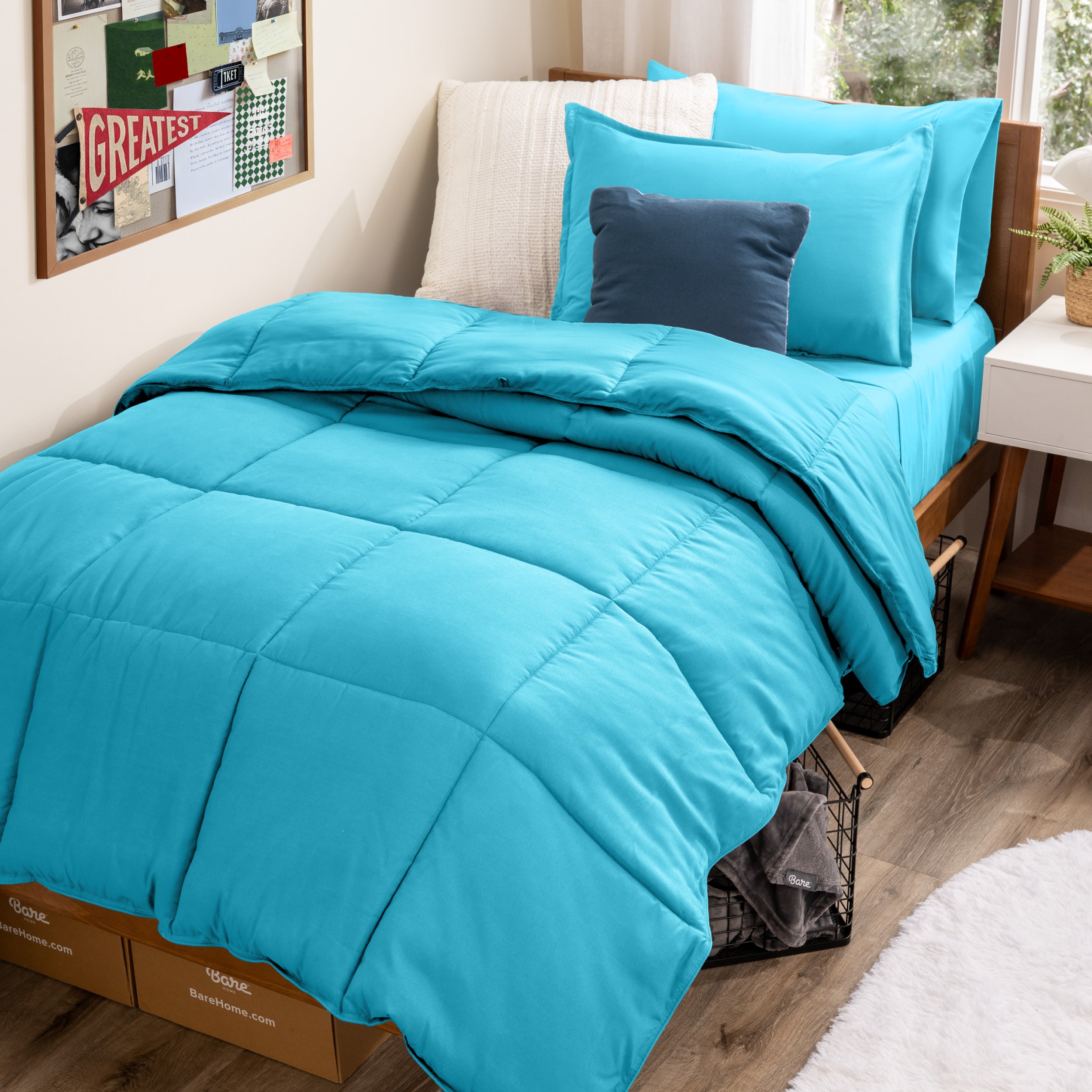 A college dorm room with a bed in a bag set on the mattress