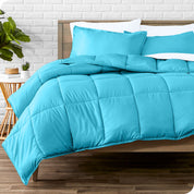A wooden bed frame with sheets, pillow shams and a comforter on the bed