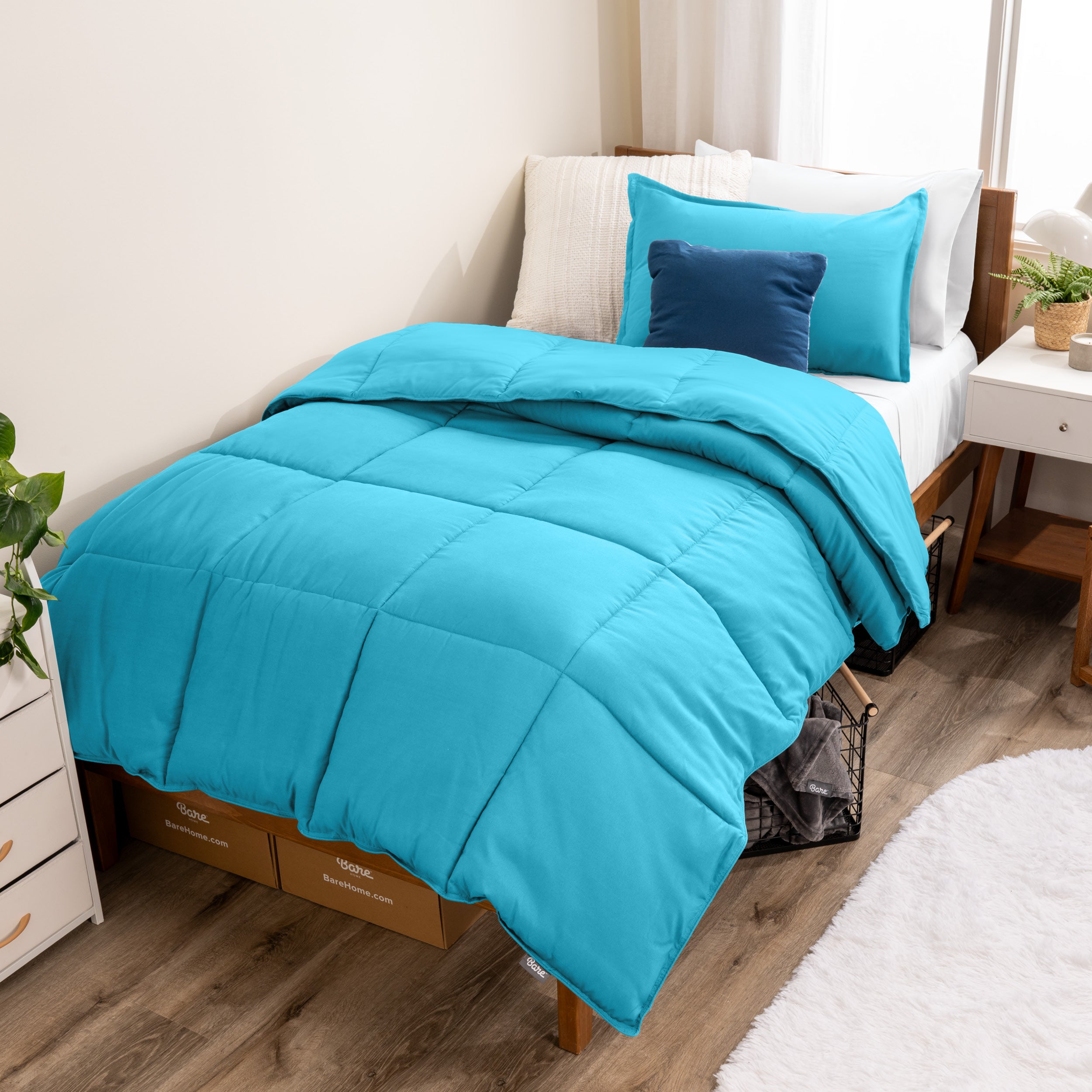 A modern bed with a down alternative comforter set on it
