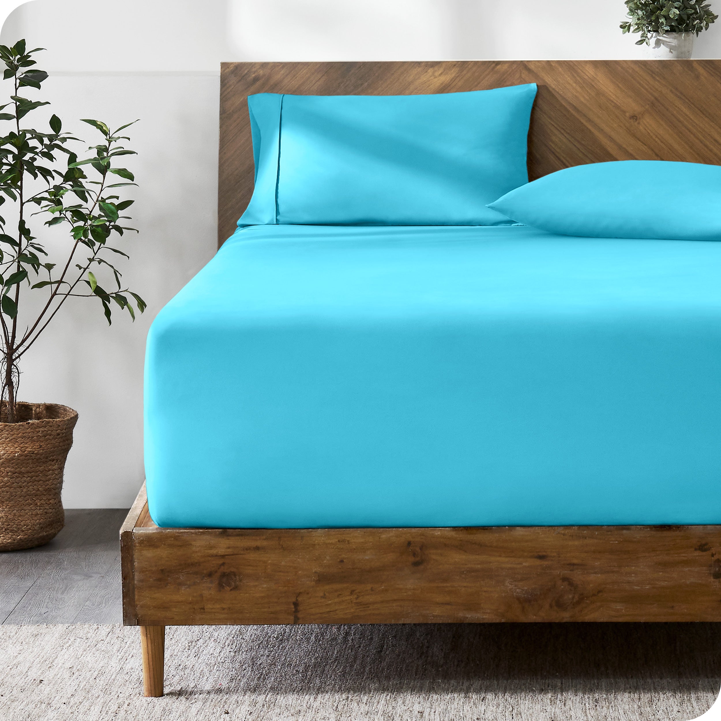 A modern bed with a fitted microfiber sheet made on the mattress. 