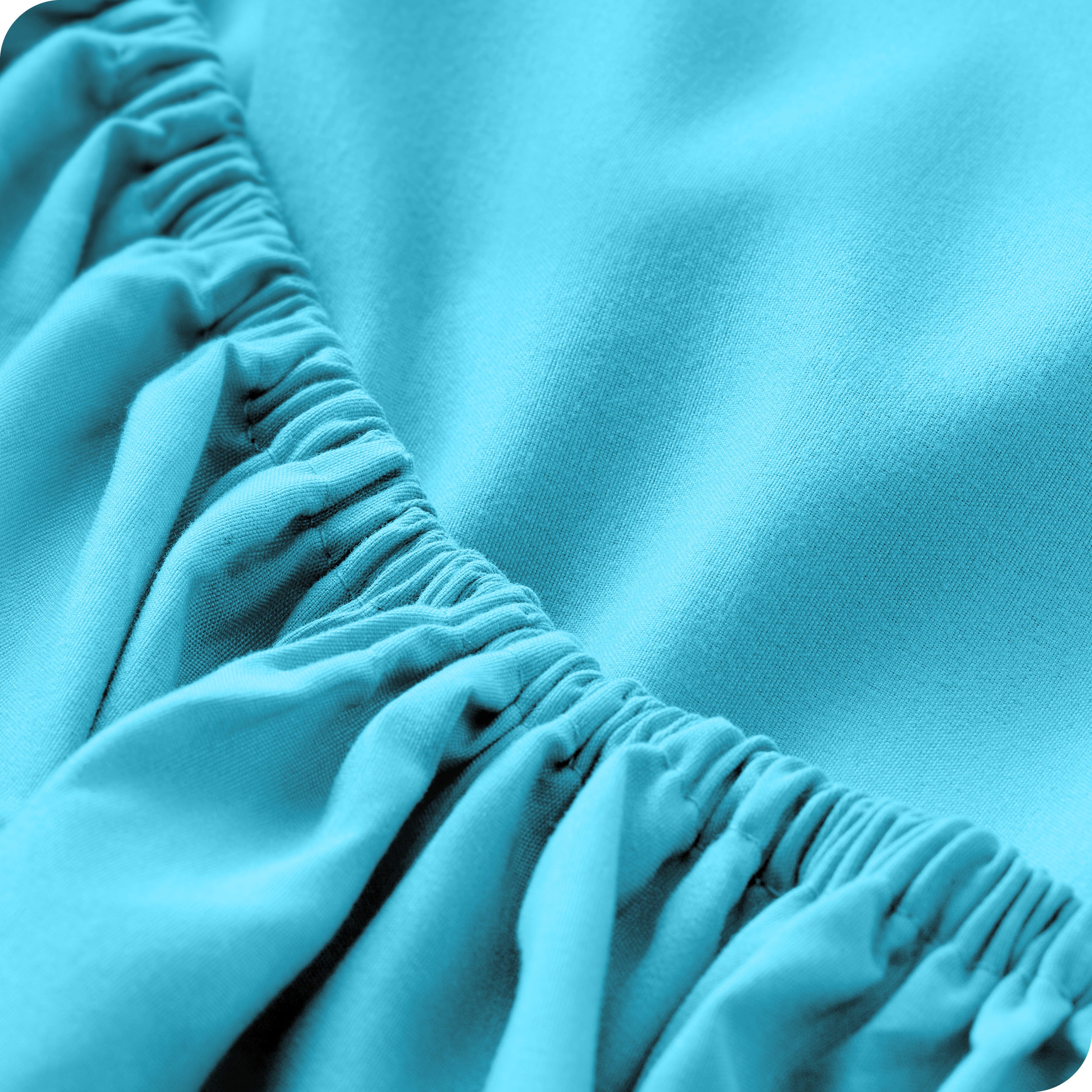A modern bed with a fitted microfiber sheet on it