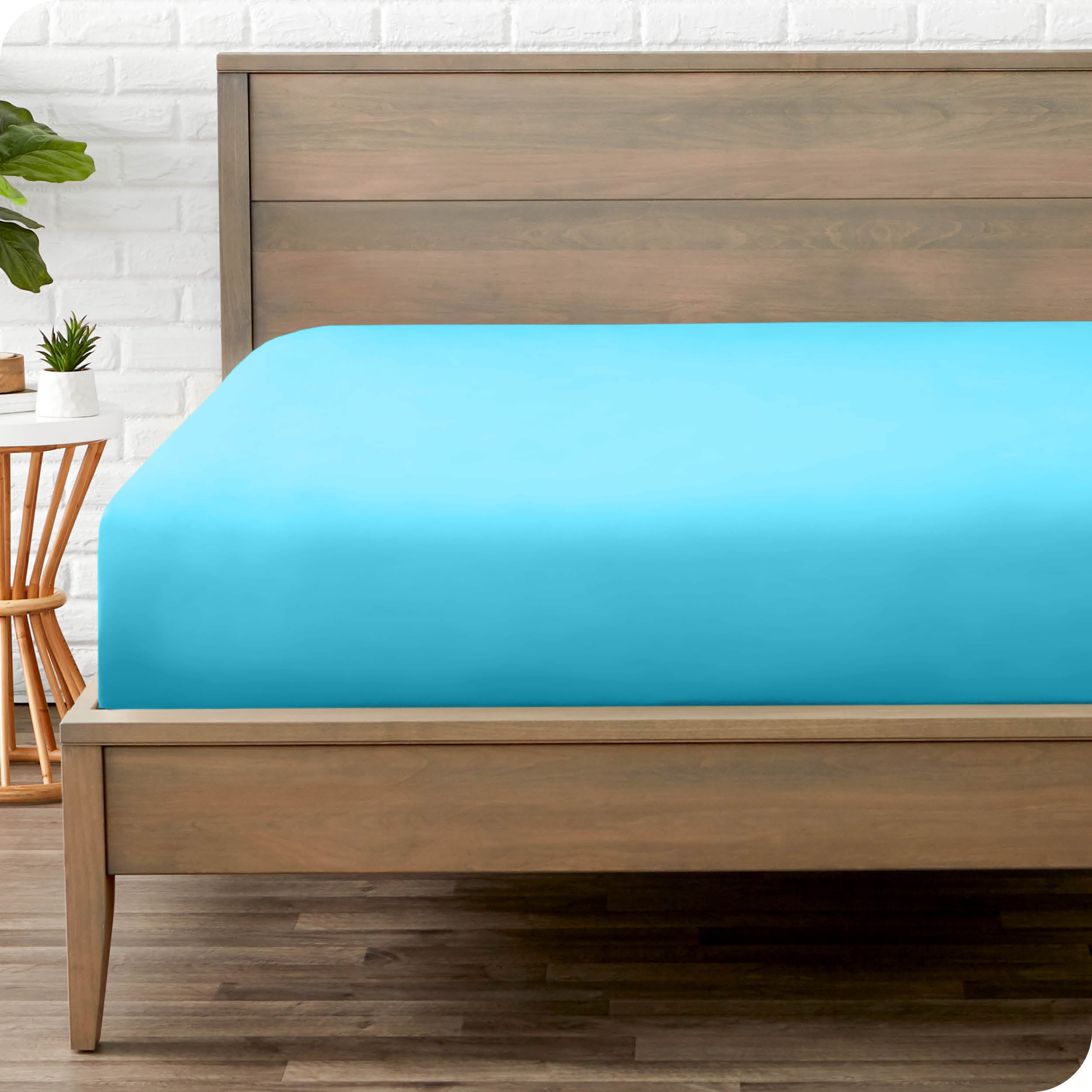 End of bed view with fitted sheet made on the mattress of a modern bed. 
