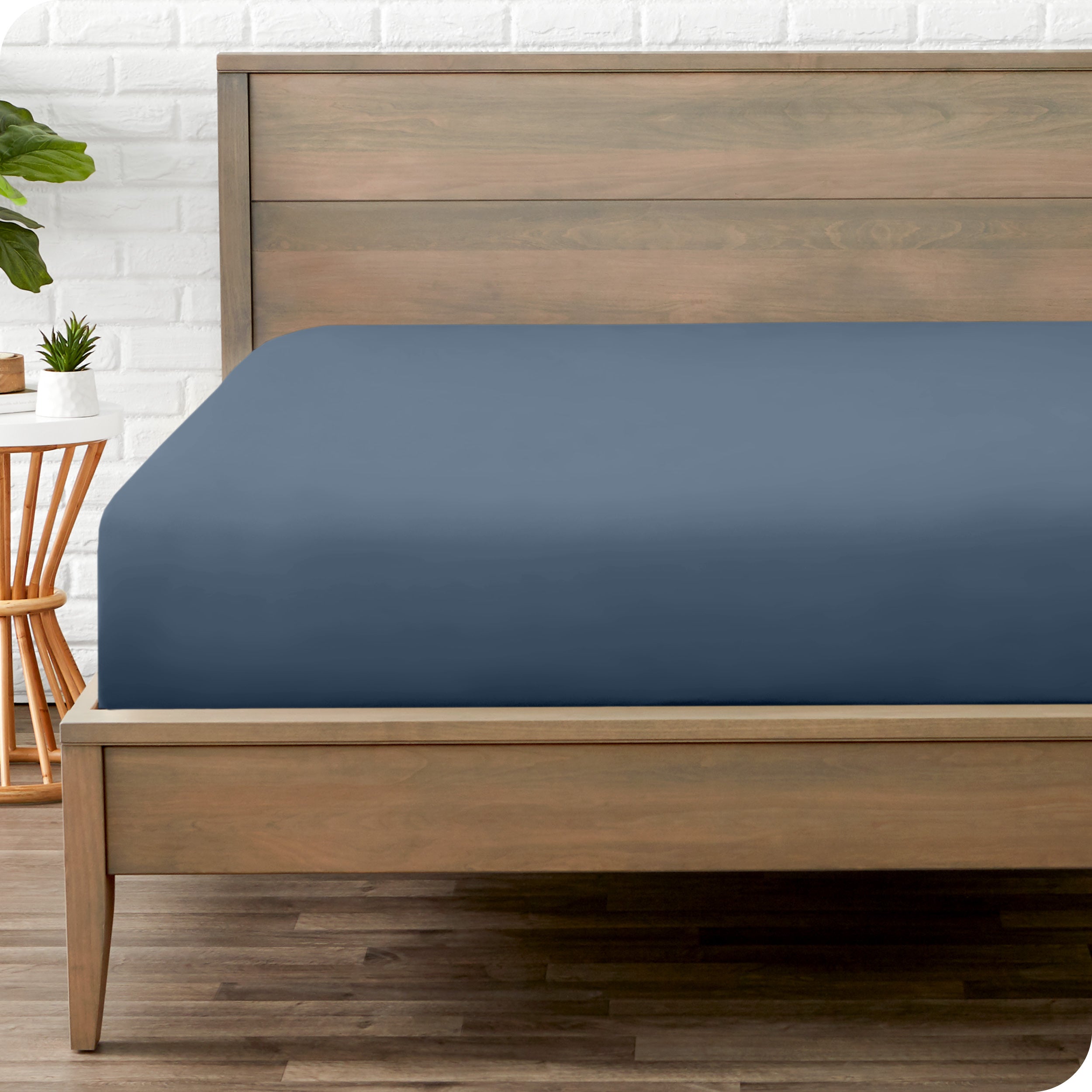 End of bed view with fitted sheet made on the mattress of a modern bed. 