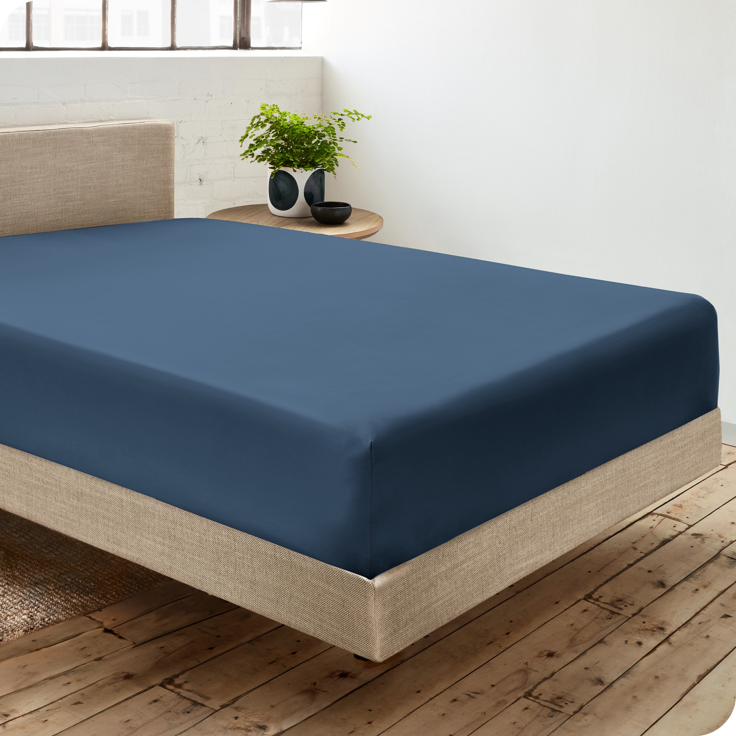 A single organic cotton fitted sheet on a bed