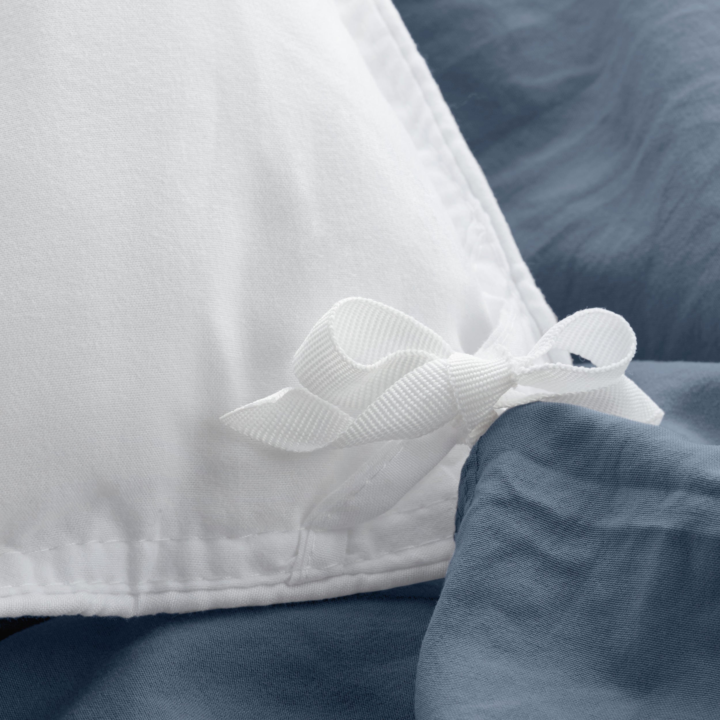 Close up of cloth ties for attaching duvet insert to inside of duvet cover