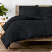 A wooden bed frame with sheets, pillow shams and a comforter on the bed