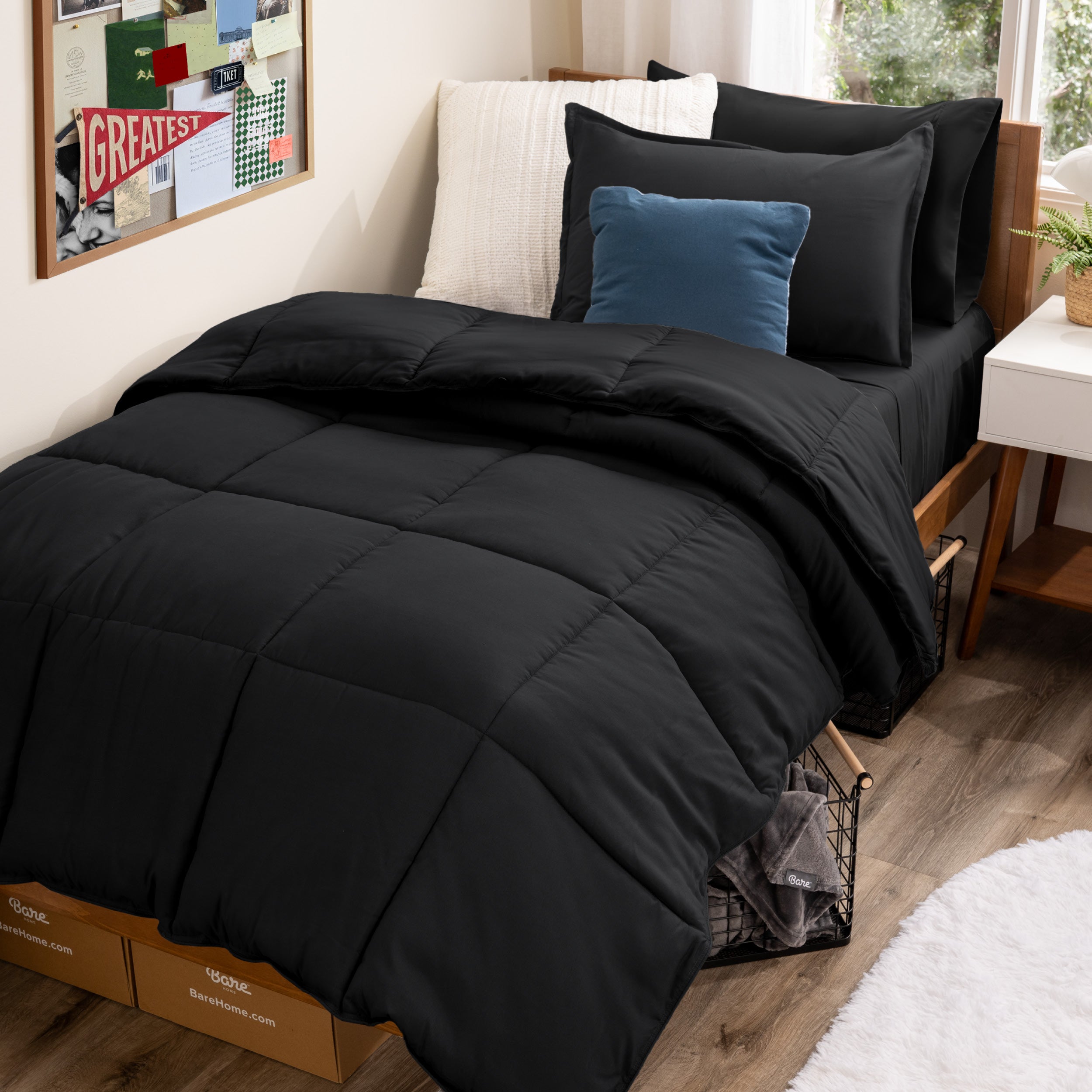 A college dorm room with a bed in a bag set on the mattress
