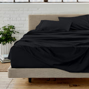 Microfiber sheet set on a bed with a white brick wall in the background