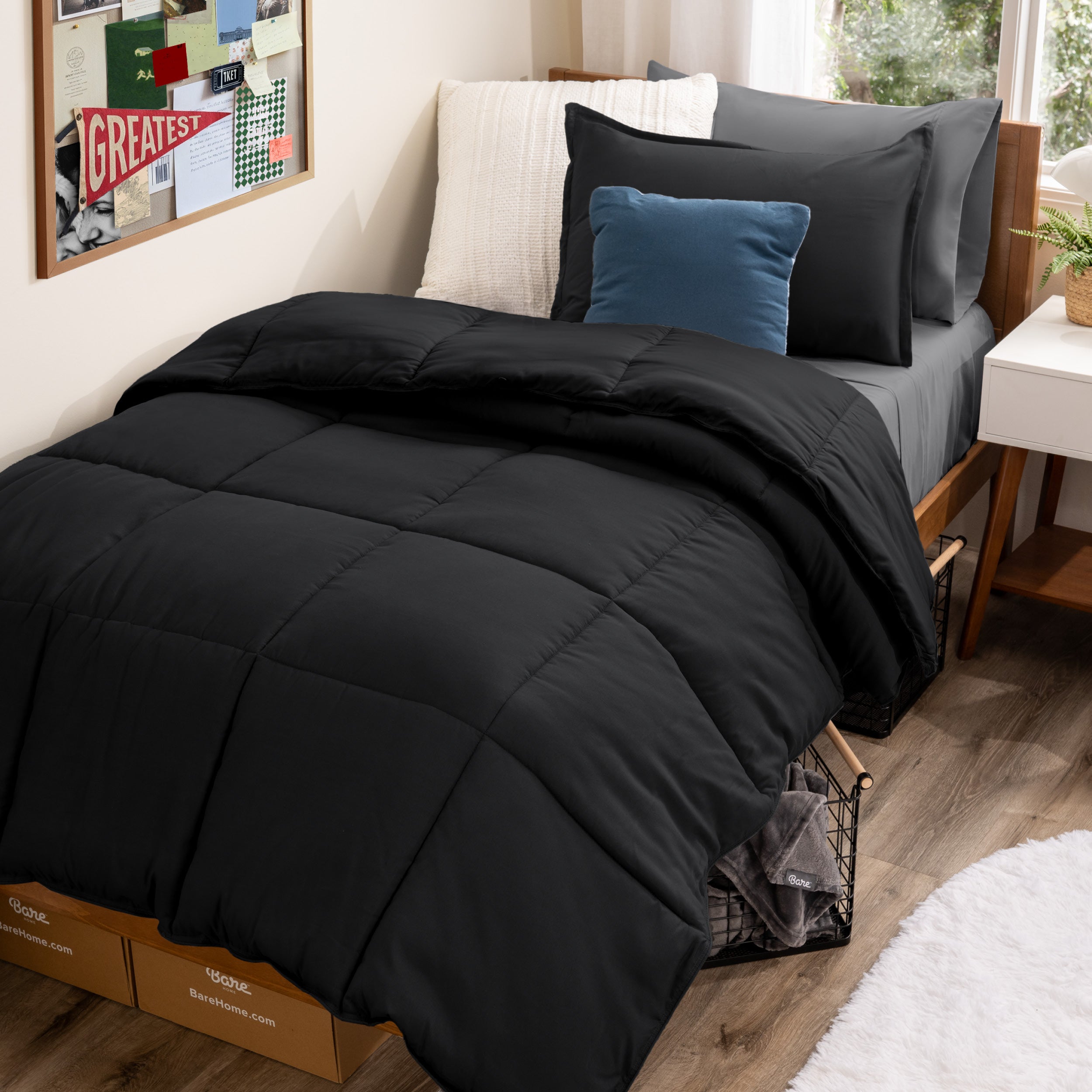 A college dorm room with a bed in a bag set on the mattress