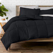 A wooden bed frame with sheets, pillow shams and a comforter on the bed