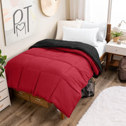 Wooden bed frame with a reversible comforter on the bed. The comforter is folded back over showing the two different colors.