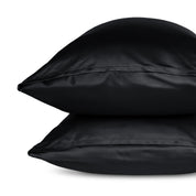 Two pillows with pillowcases stacked on a white background