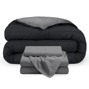 A reversible microfiber comforter and a coordinating sheet set folded and stacked 