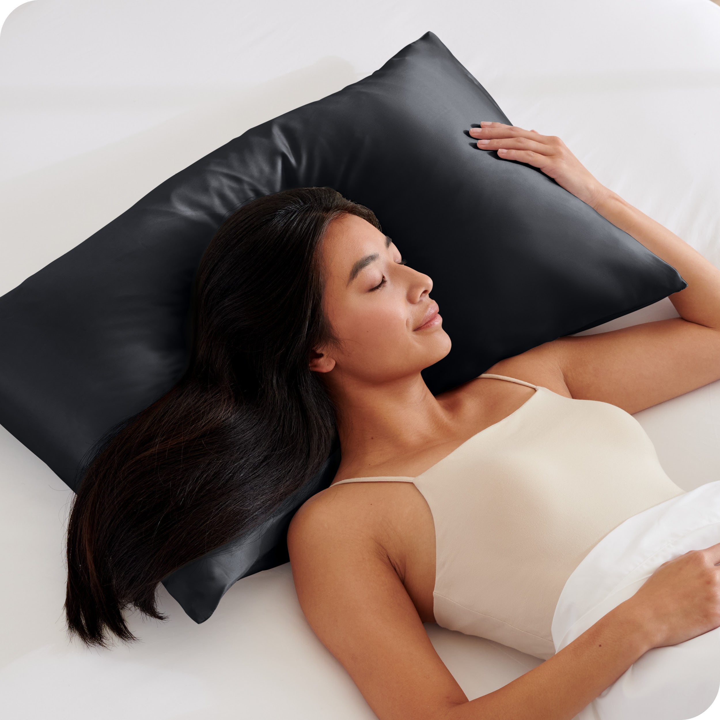 A woman sleeping with her head on a pillow