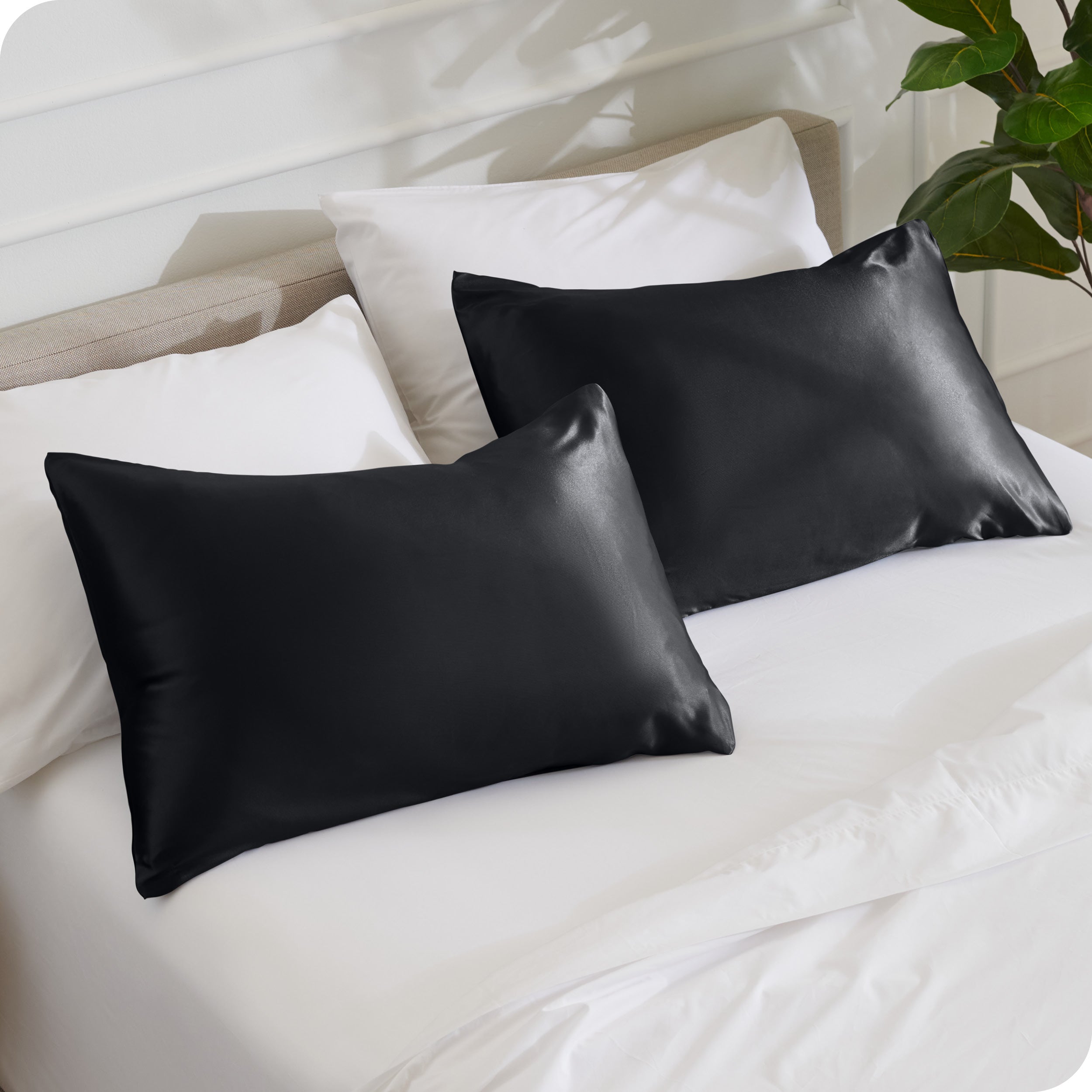2 silk pillowcases on pillows set on a bed