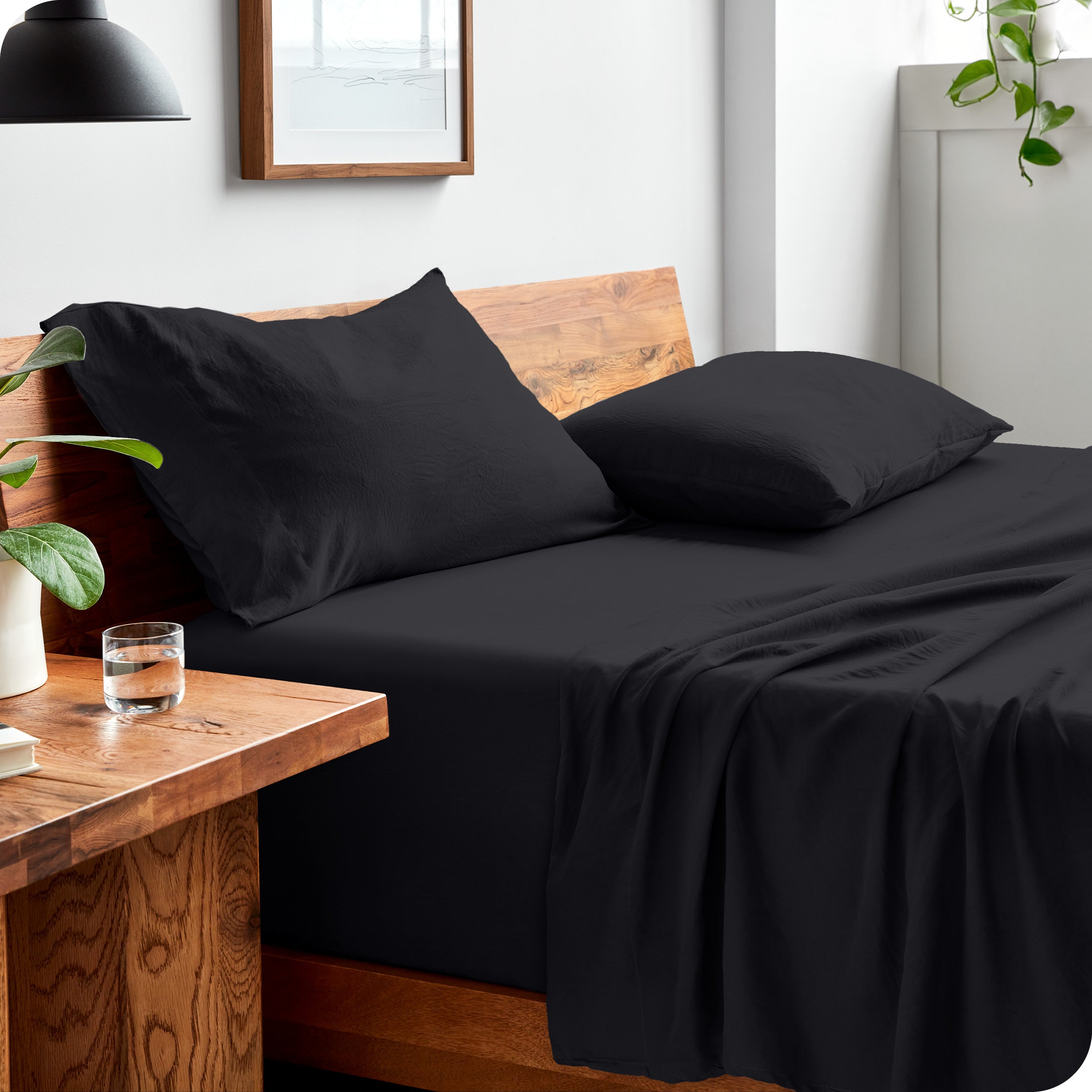 Side view of bed made with fitted sheet, pillowcases, and top sheet