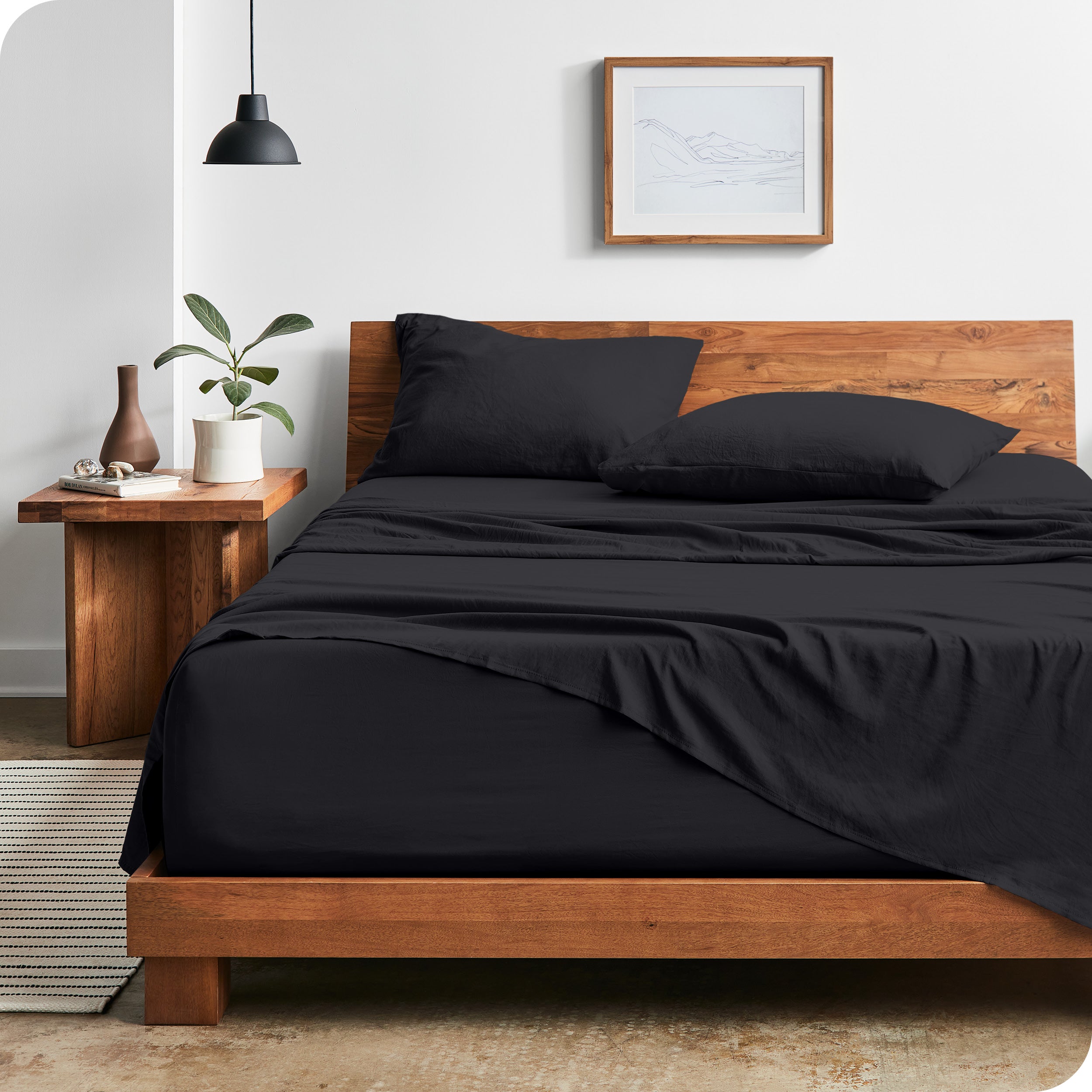 Modern bedroom with Sandwashed sheets draped over the end and side of mattress
