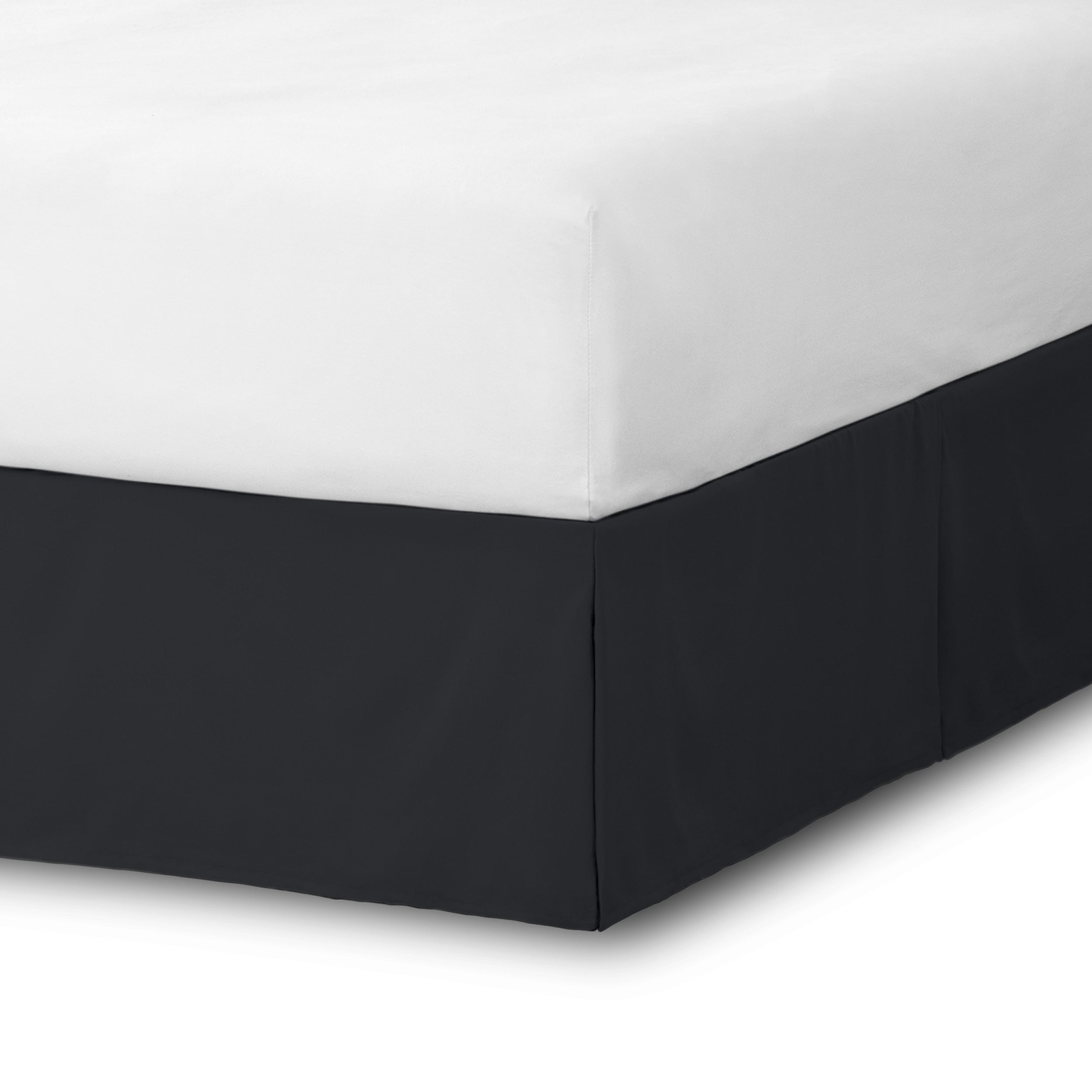 The corner of a bed skirt on a bed frame