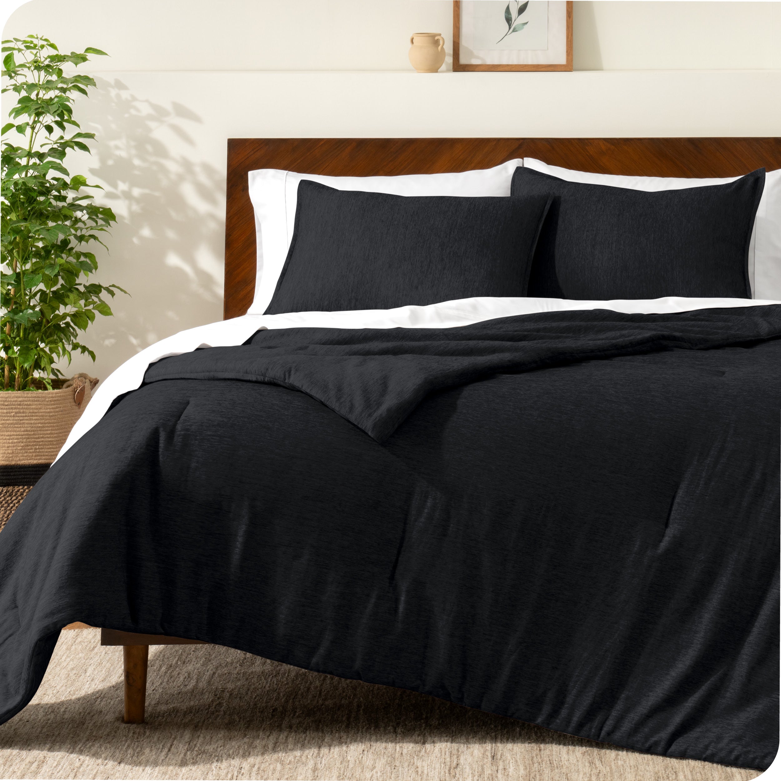 A modern bed with a down alternative comforter set on it
