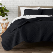 A quilted coverlet set on a bed