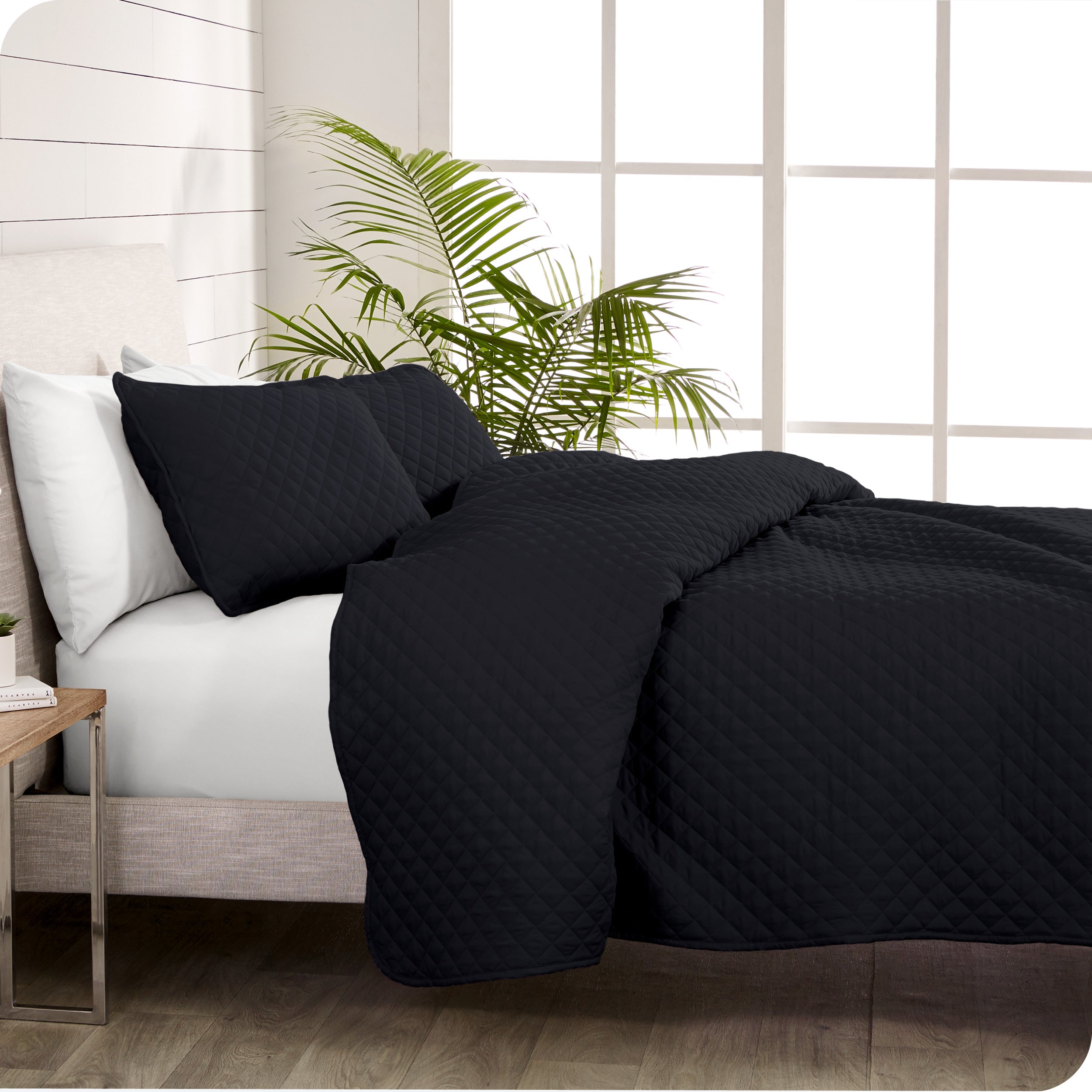 A coverlet set on a bed next to a window