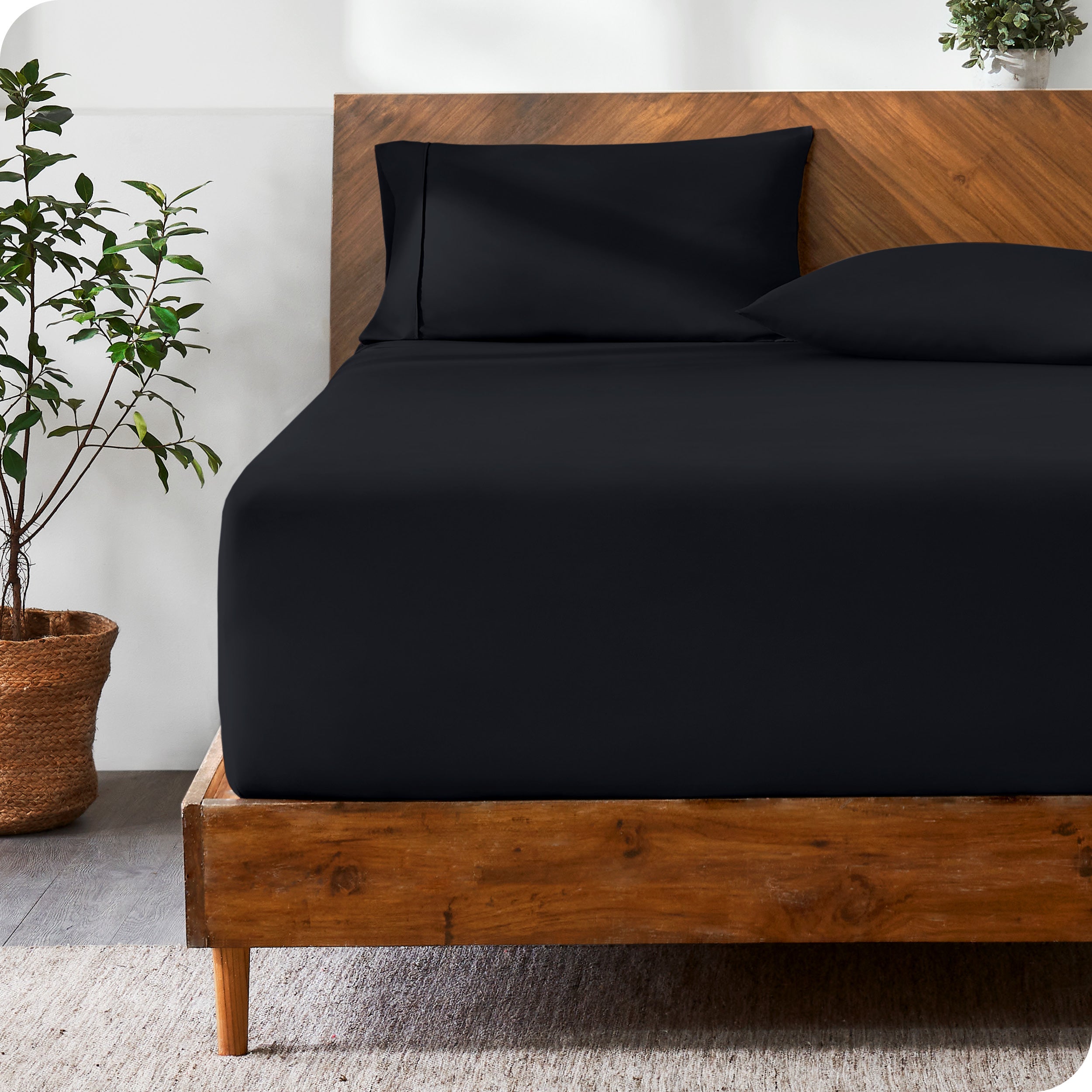 A modern bed with a fitted microfiber sheet made on the mattress. 