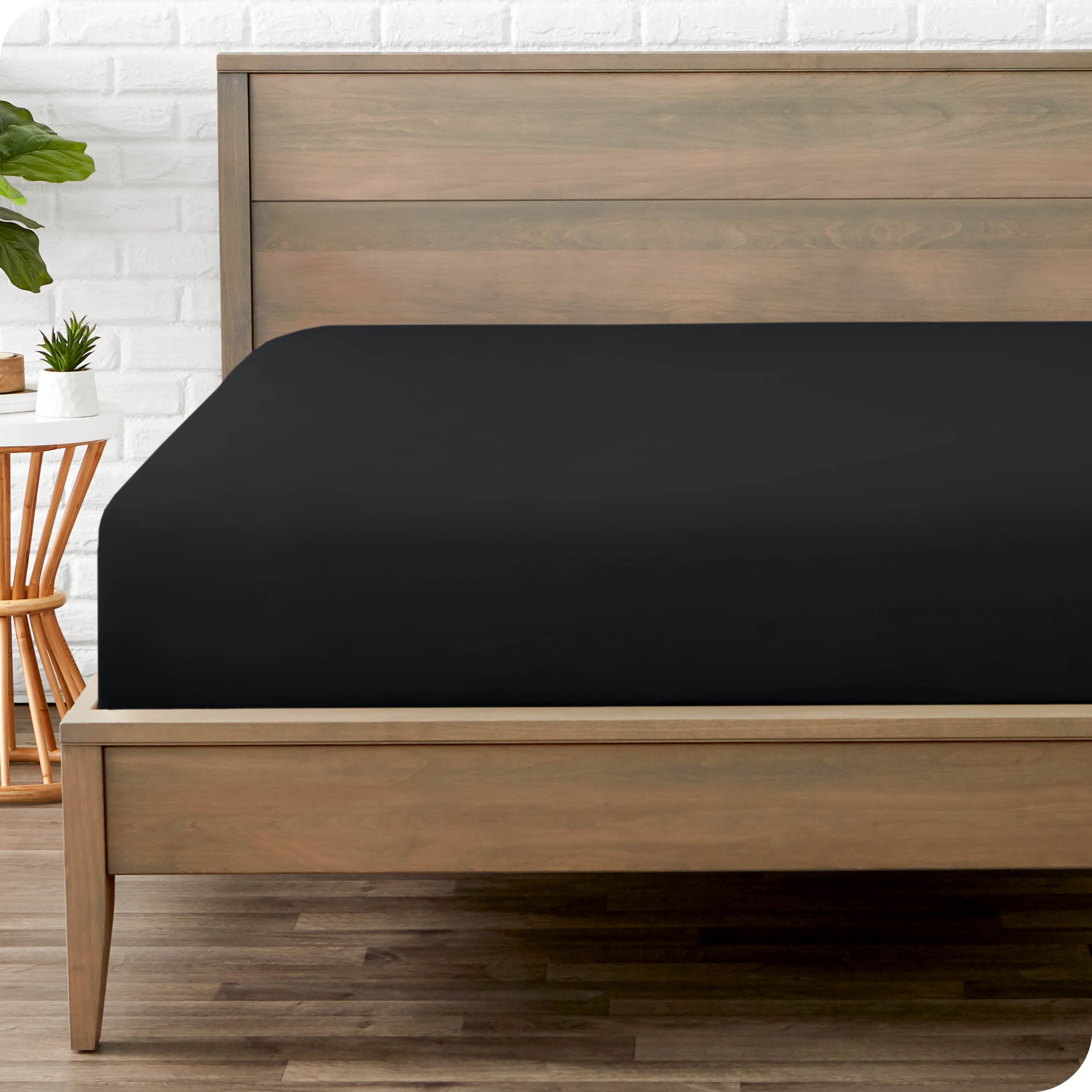 End of bed view with fitted sheet made on the mattress of a modern bed. 