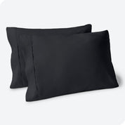 Two pillows on a white background with blue pillowcases on them