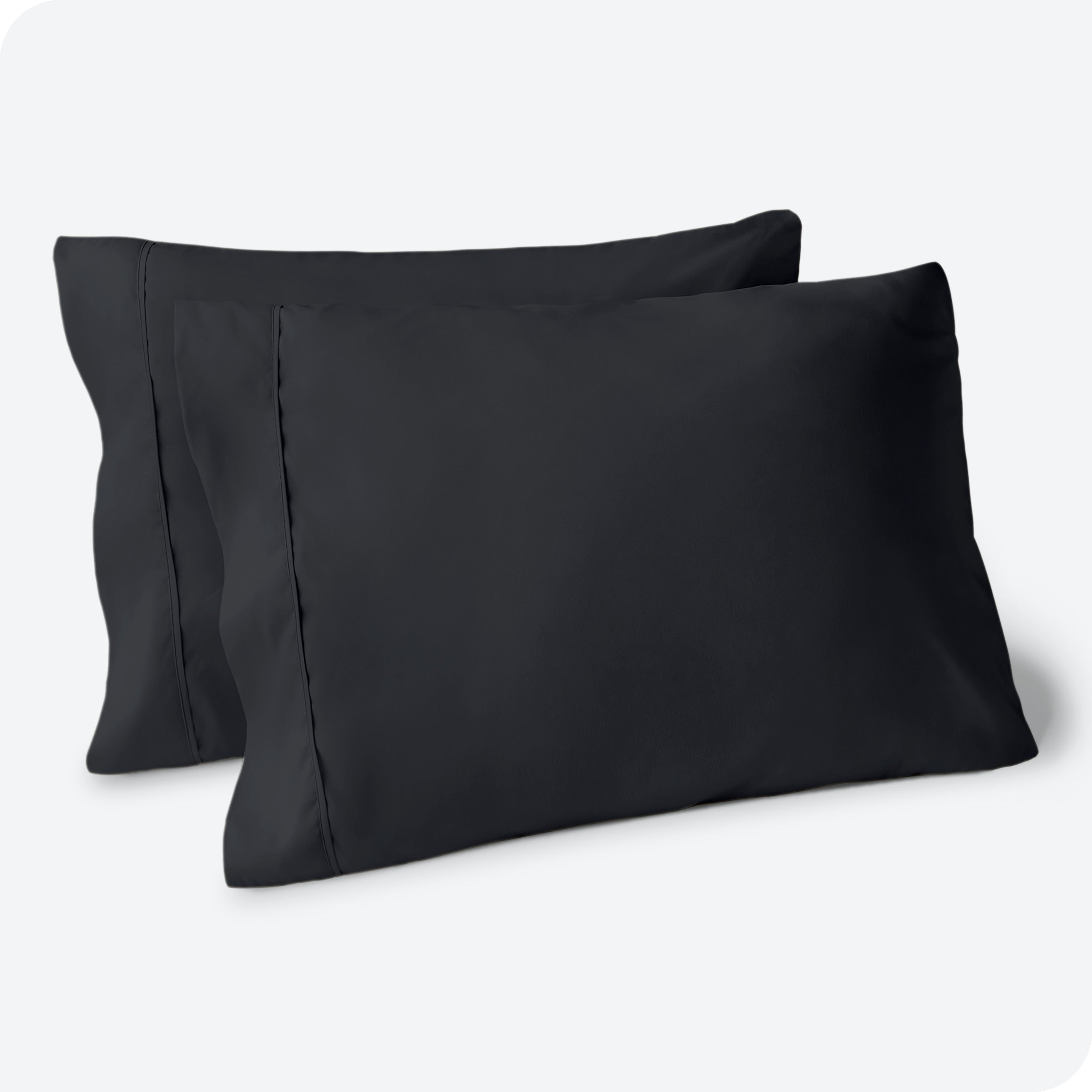 Two pillows on a white background with blue pillowcases on them