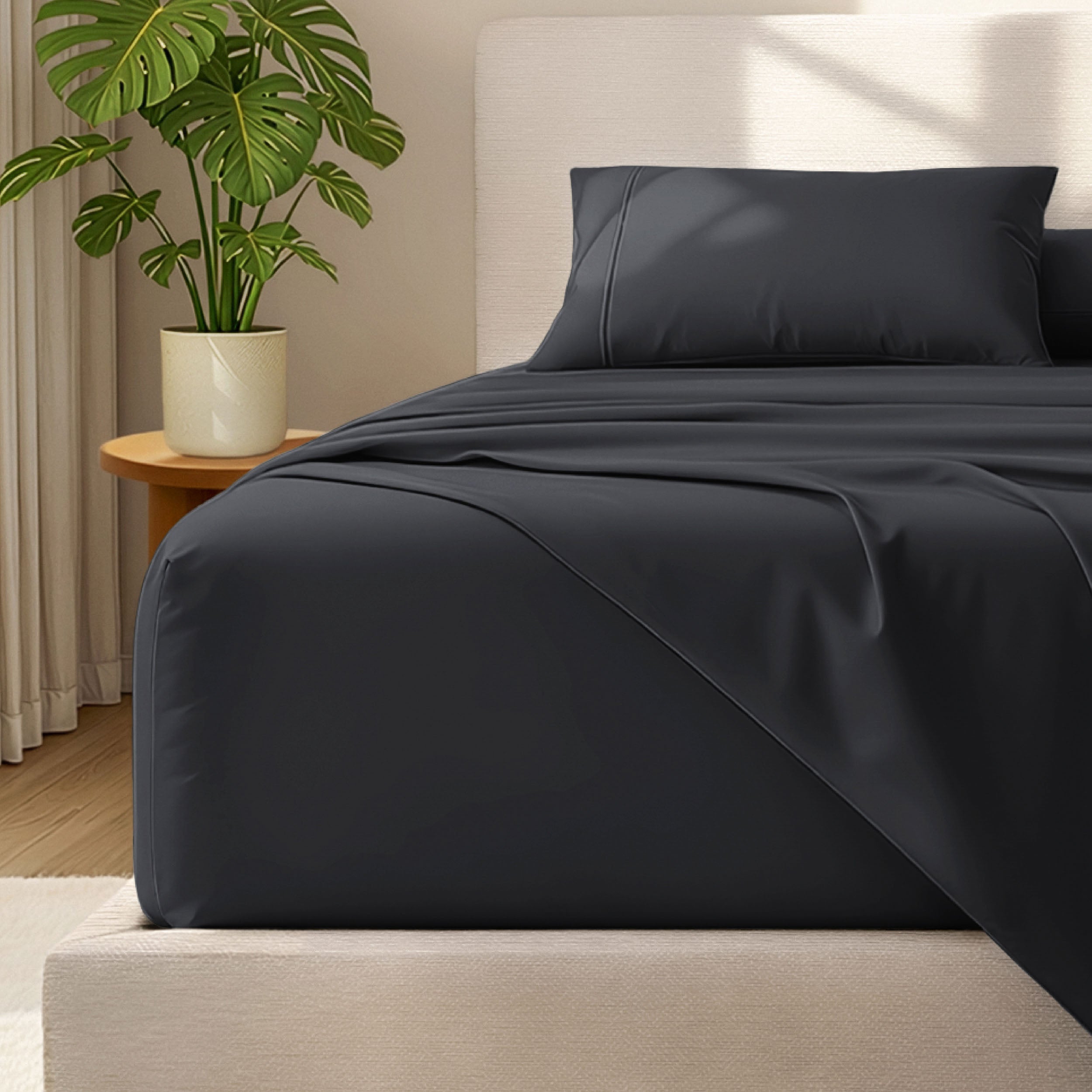 Microfiber bed sheets and pillowcases on a bed with a plant in the background