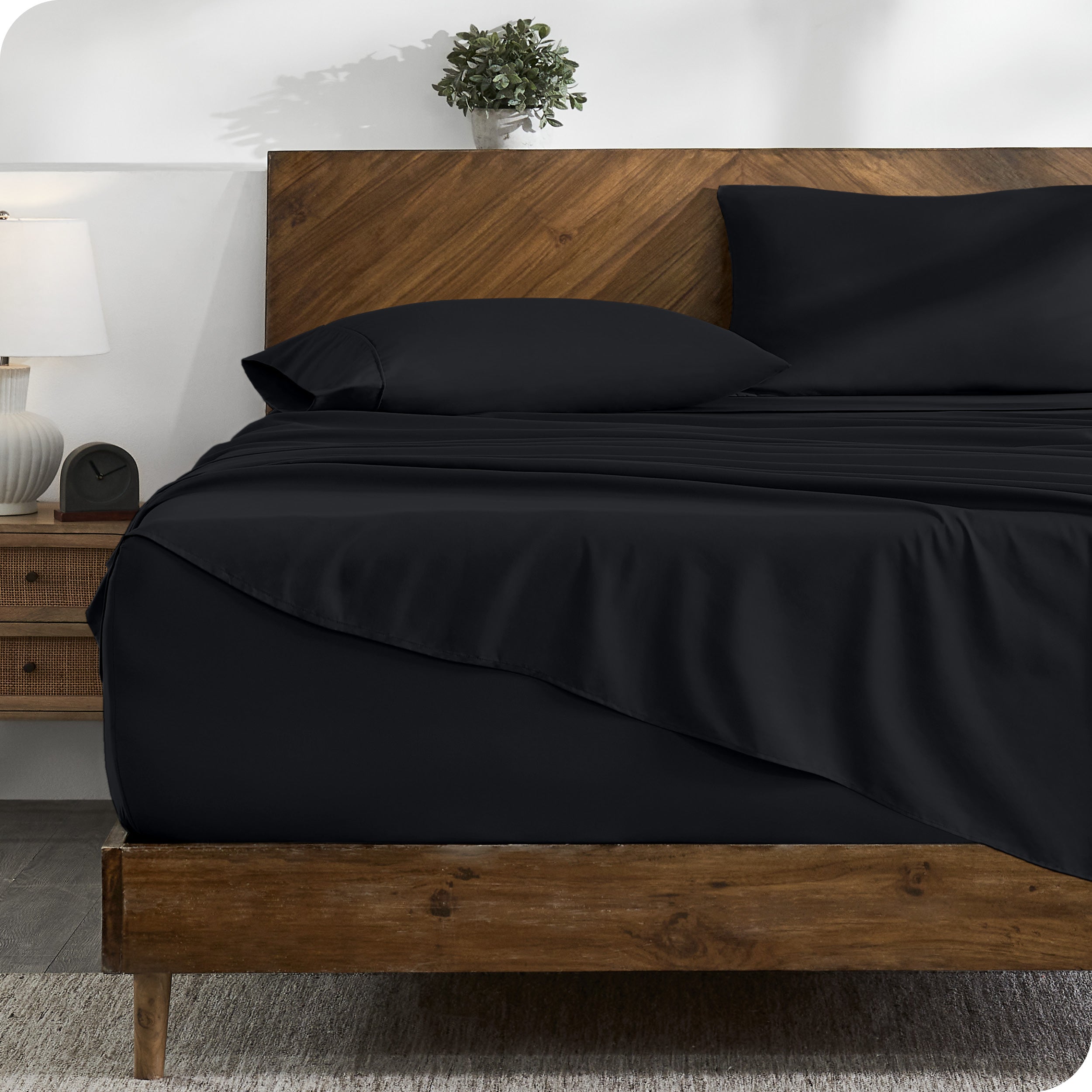 A cozy bedroom with a bed covered in soft microfiber sheets

