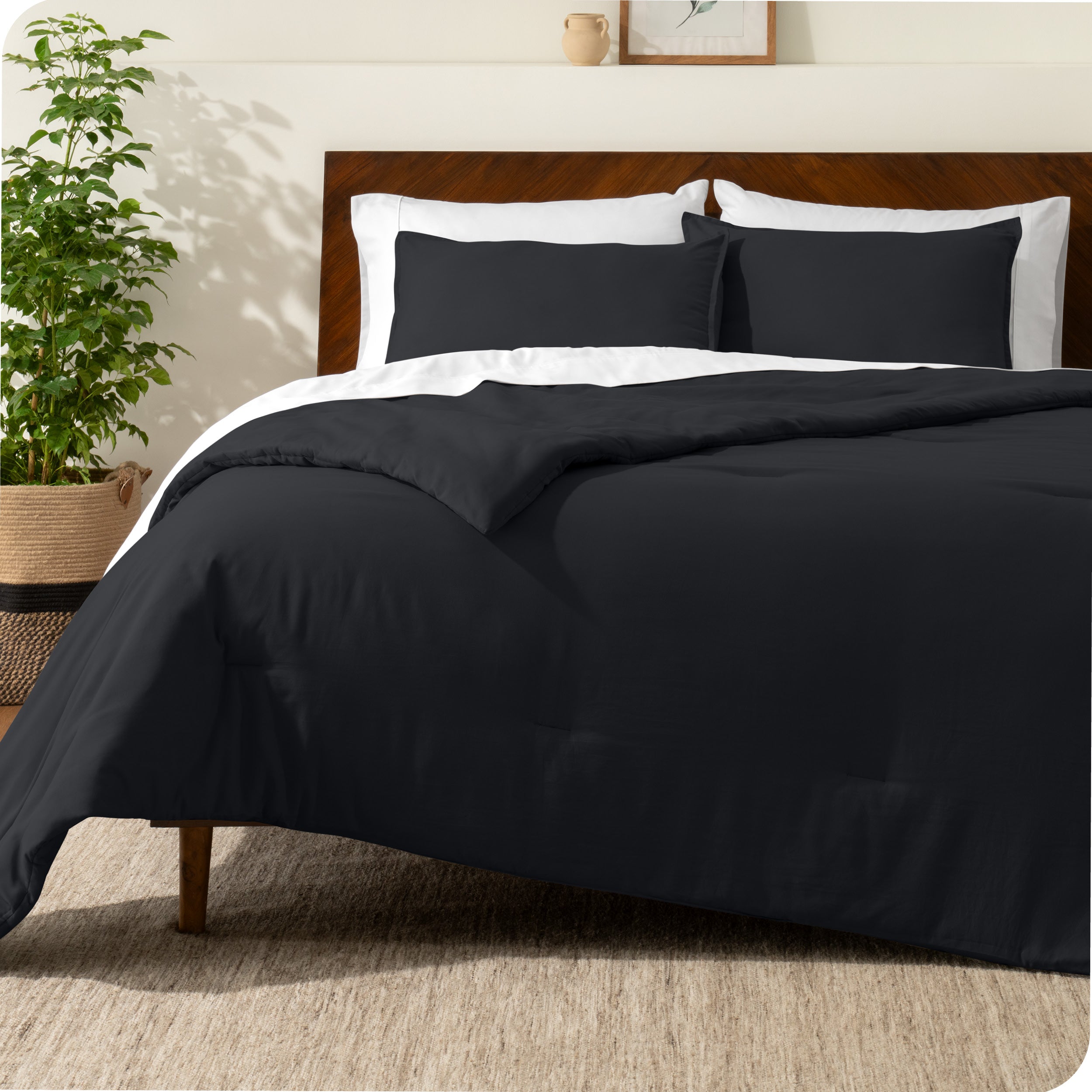 A comforter set on a bed with a dark wooden headboard