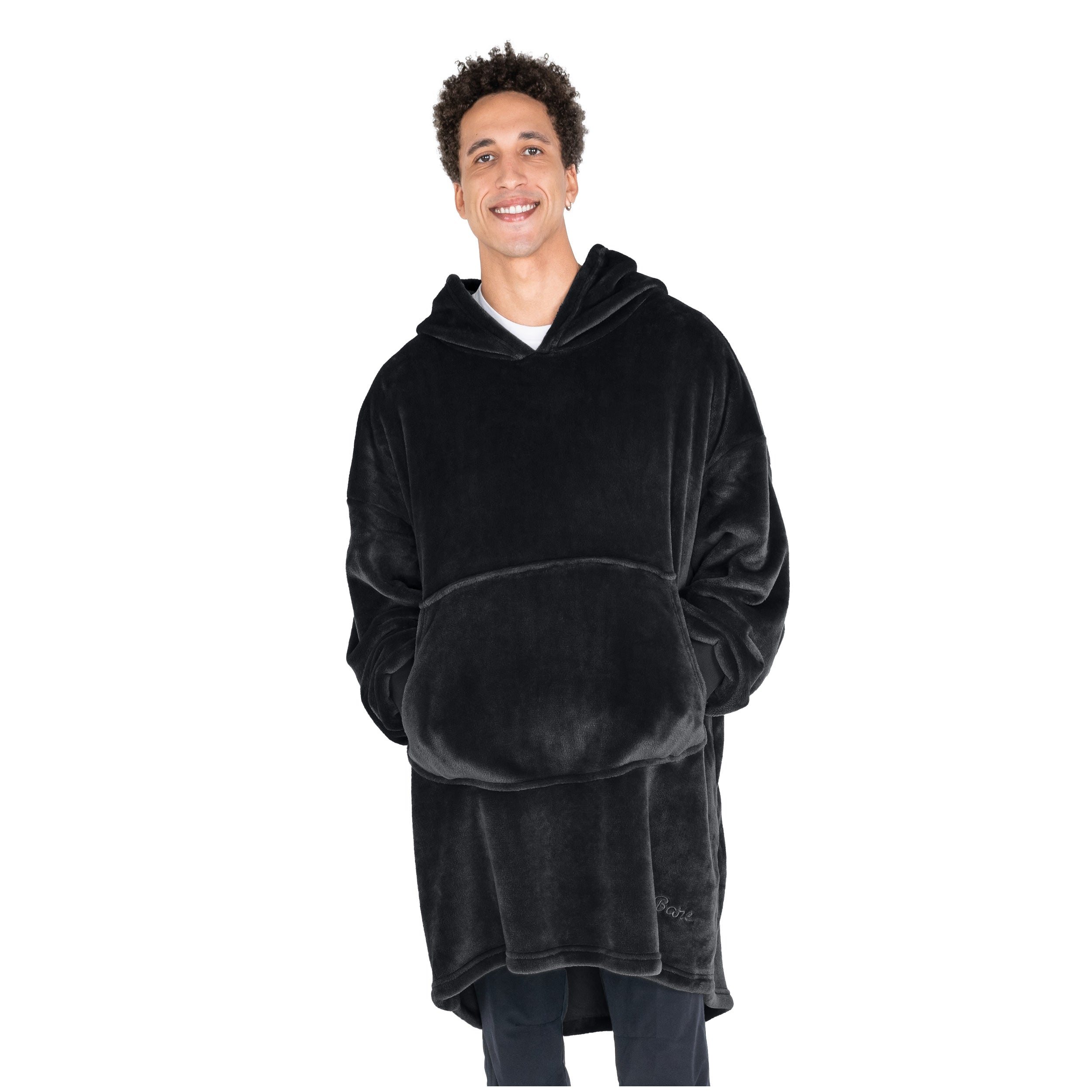 An adult with microplush wearable blanket on