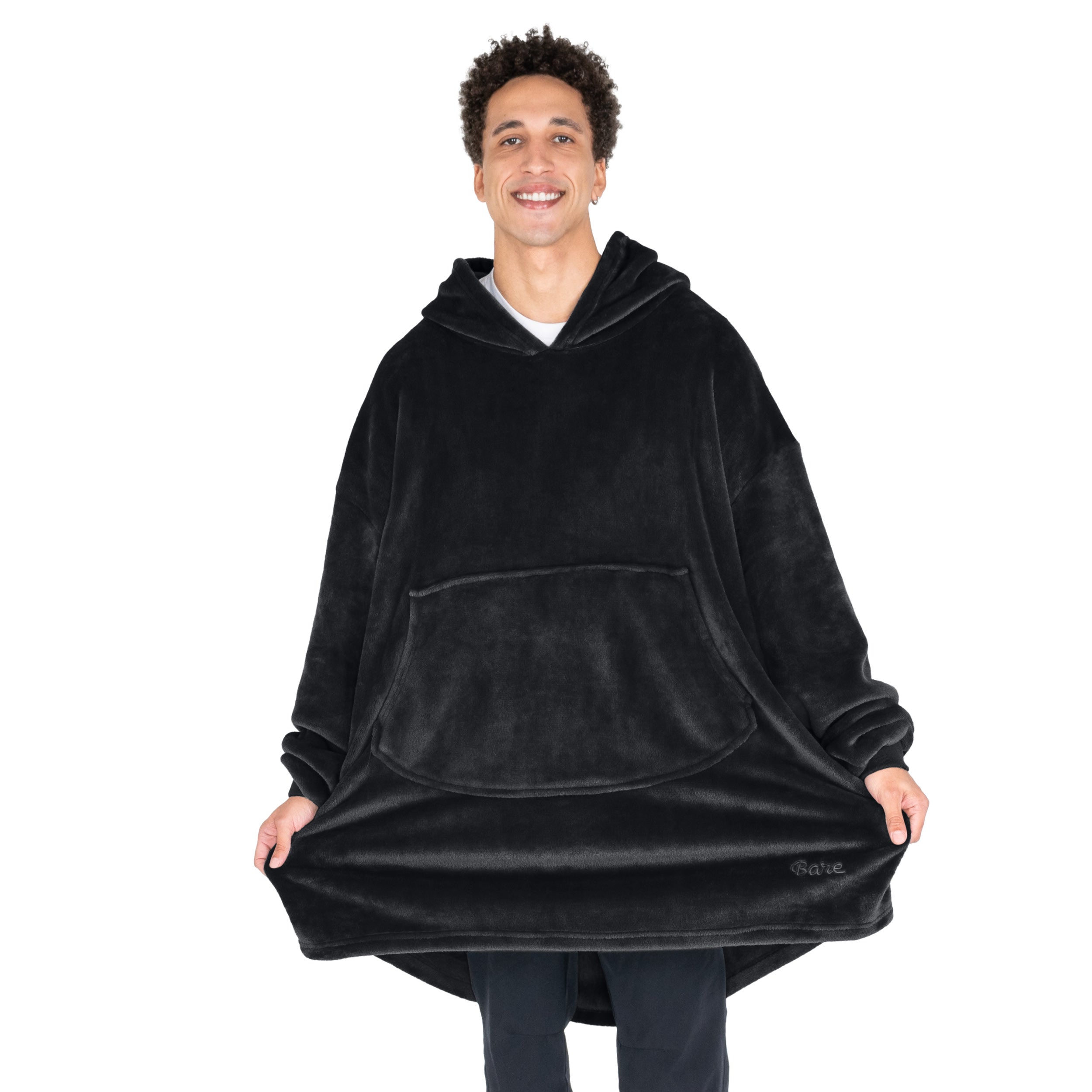 An adult with microplush wearable blanket on