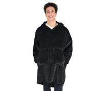 A man with his hands in the pockets of the wearable blanket he has on