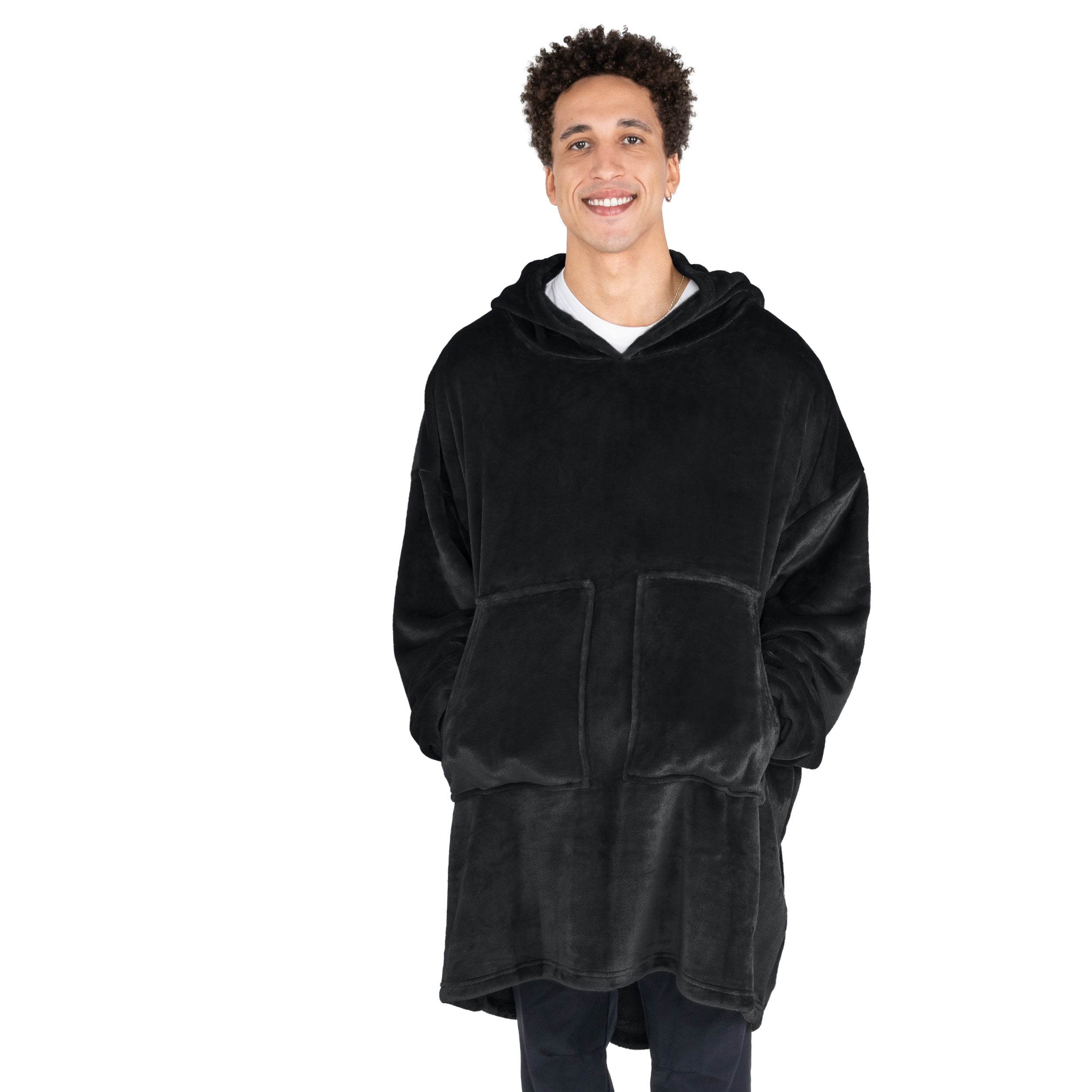 A man with his hands in the pockets of the wearable blanket he has on