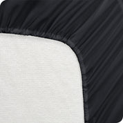 A mattress pad wrapped around the side and back of a mattress