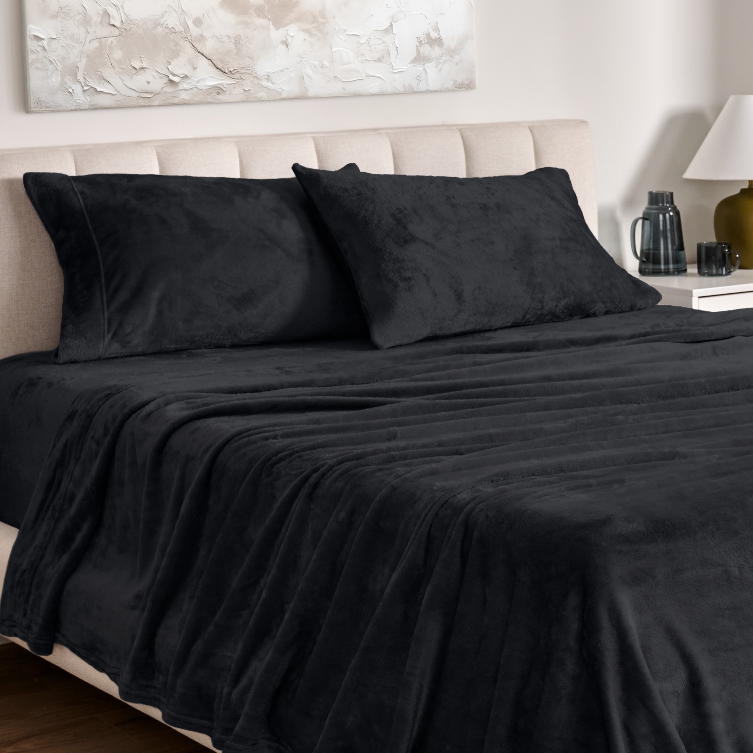 Microplush bed sheets and pillowcases on a bed with a neutral headboard and decor.