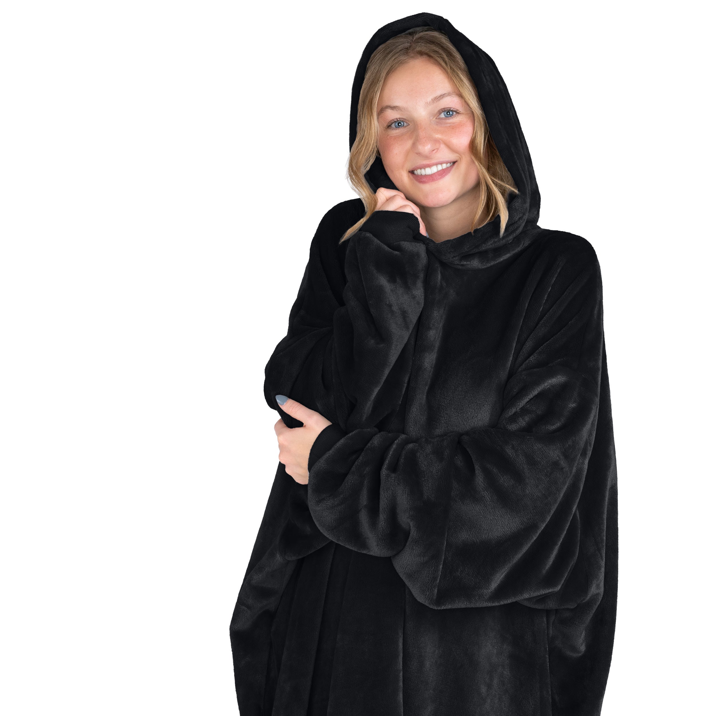 A smiling woman has a hooded wearable blanket on