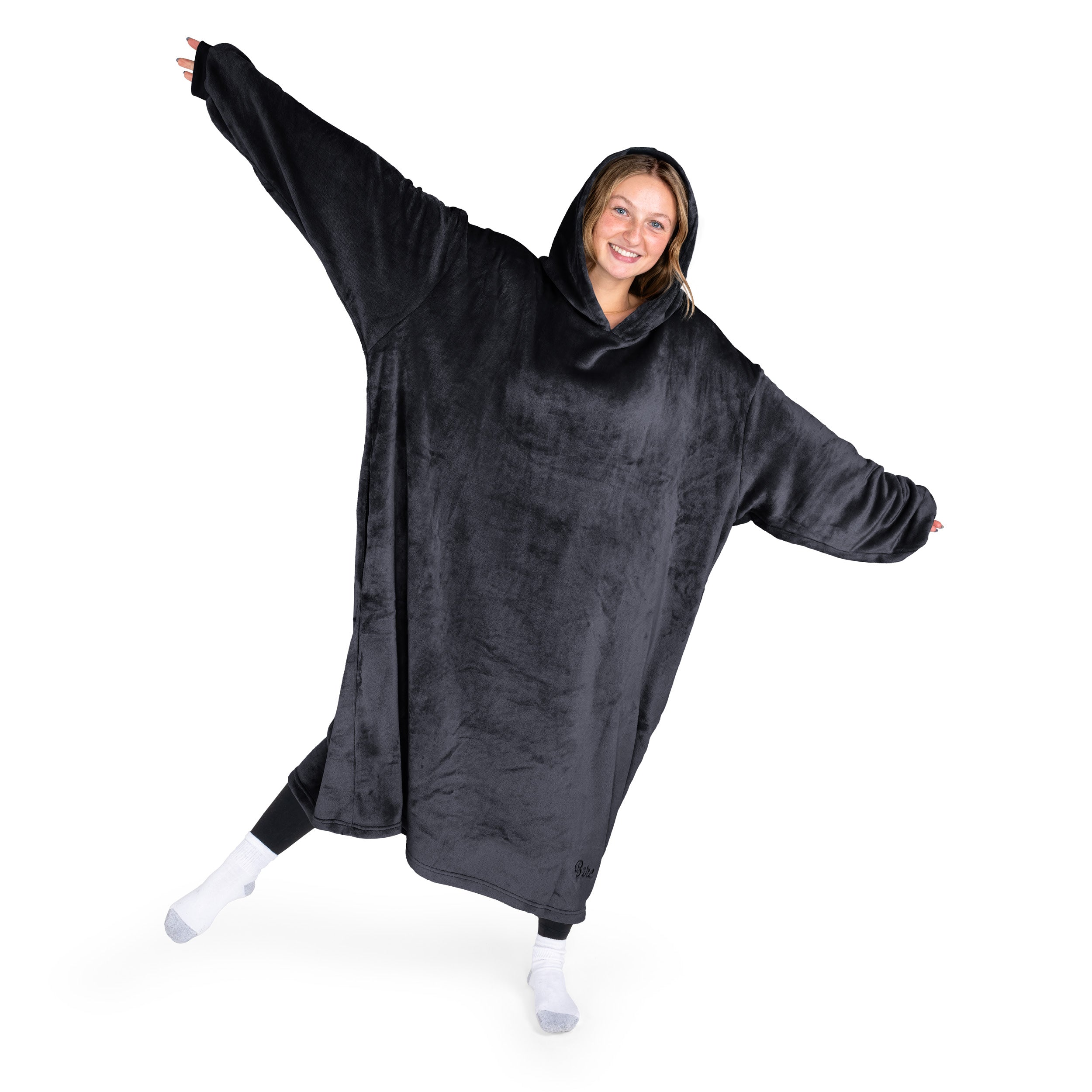 A woman has a hooded wearable blanket on